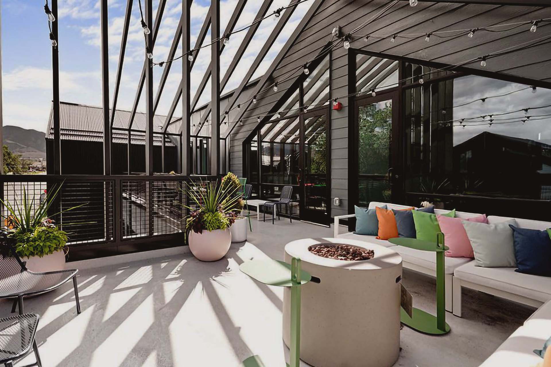 Rooftop patio with comfortable seating and fire pit at the Izzy.